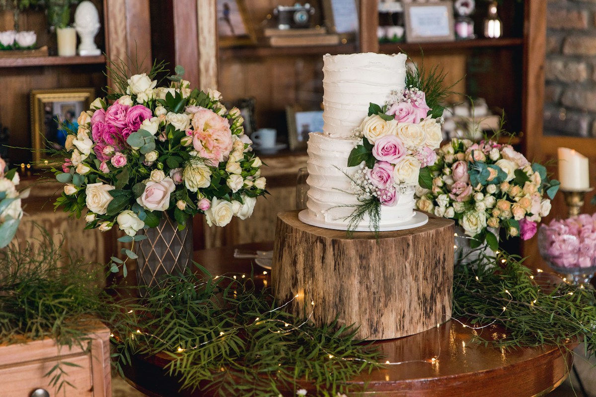 Celebration cake surrounded by white and pink flowers